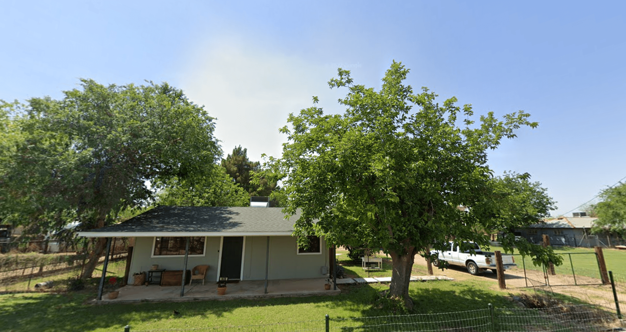 Existing house at 5636 S. 27th Pl in Phoenix, with mature trees and a covered porch.